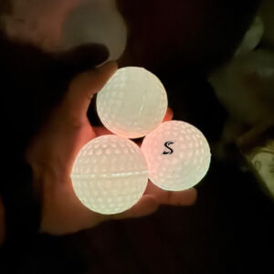 Premium Glow-in-the-Dark Hurling Ball with UV-activated glow technology, dimple performance surface, high visibility, and professional training quality for Hurling, Camogie & Gaelic Games.